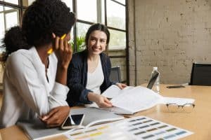 Two attractive smart multiethnic women entrepreneurs